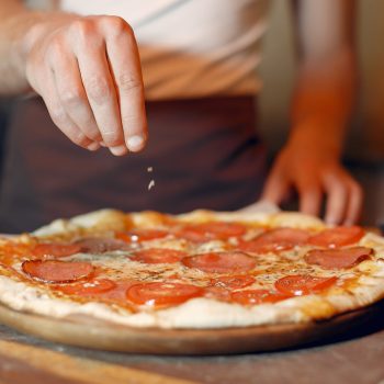 Chef prepare the pizzaa. Man in a white uniform